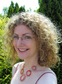 mauramchugh Headshot of Maura McHugh - a blond curly-haired woman wearing glasses - outdoors in a garden. Image used by permission of the author.