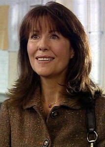 Elisabeth Sladen as Sarah Jane in the Noughties: a middle-aged, smiling caucasian woman with straight bangs and long dark hair, in a brown shirt. Image via Wikipedia, shared under Creative Commons licence