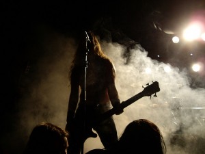 Photo of a live Moonsorrow gig. Lead singer Ville is silhouetted against a backdrop of dry ice. You can make out the shape of his guitar and long hair.