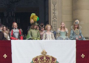 Photo: the cast of the film stood on a balcony. The women are all standing next to each other. Photo from Wikipedia, shared under Fair Use guidelines and copyright Summit Entertainment.